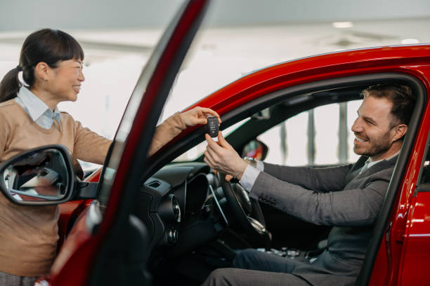 istock Key handover at car dealership 2155006819