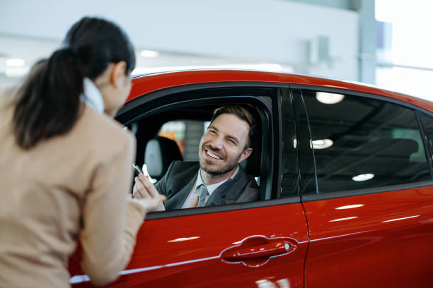 istock Sales interaction with happy male customer in car 2155006822