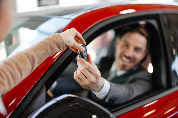 istock Handing over car keys to a happy man 2155006862