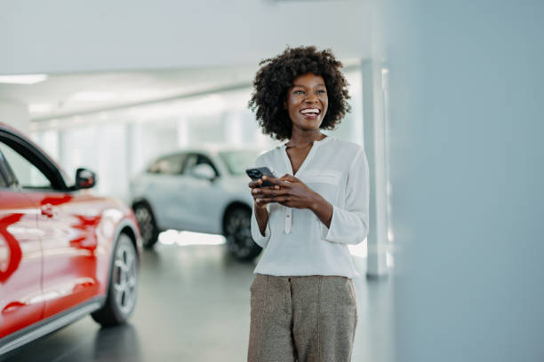 istock Smiling woman holding a phone 2155006937