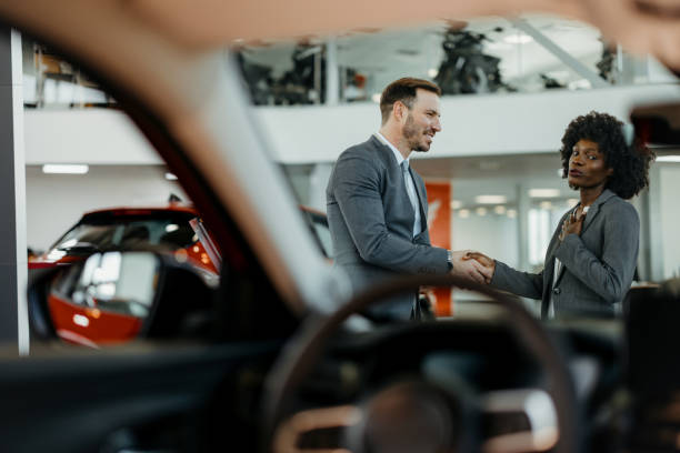 istock Sales conversation inside car showroom 2155007557