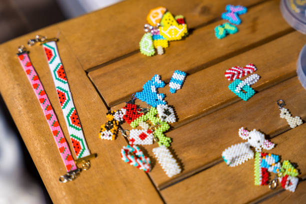 Plastic egg box being used to store plastic beads for children's crafts. Recycling and making friendship bracelets.