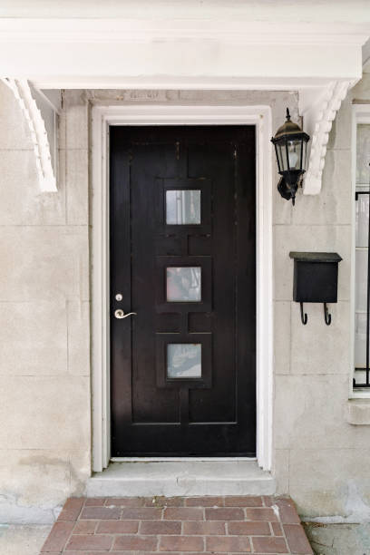 istock A mid-century modern black door with three glass windows and a black mailbox 2155009513