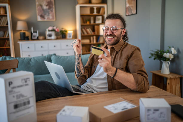 istock Happy young man receiving packages with home delivery 2155009966