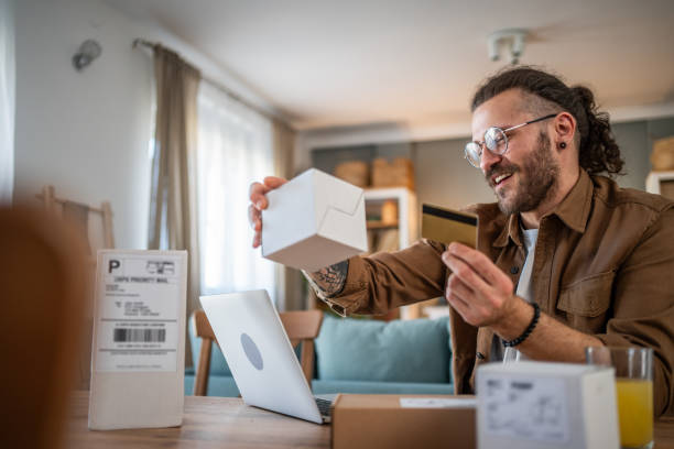 istock Happy young man receiving packages with home delivery 2155011106