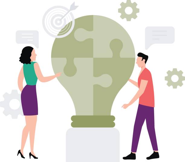 istock A girl and a boy are working on a business puzzle. 2155011637