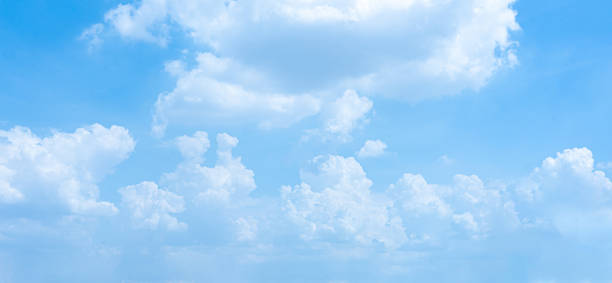 istock A bright blue sky filled with fluffy white clouds on a sunny day 2155012509