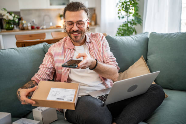 istock A happy young man has just received a package he ordered online. His excited face reflects excitement as he holds the package in his hands and checks the shipment 2155014019