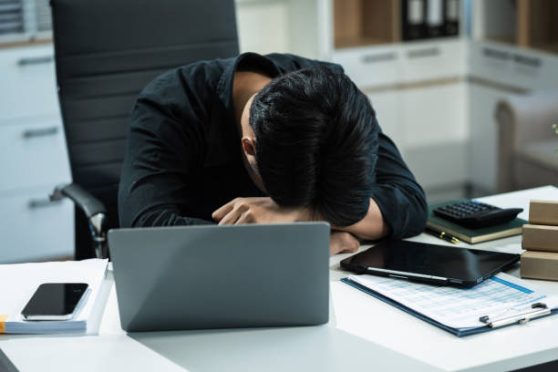istock Young stressed Asian businessman working in the office. Businessman thinking too much work concept in the office. 2155018753
