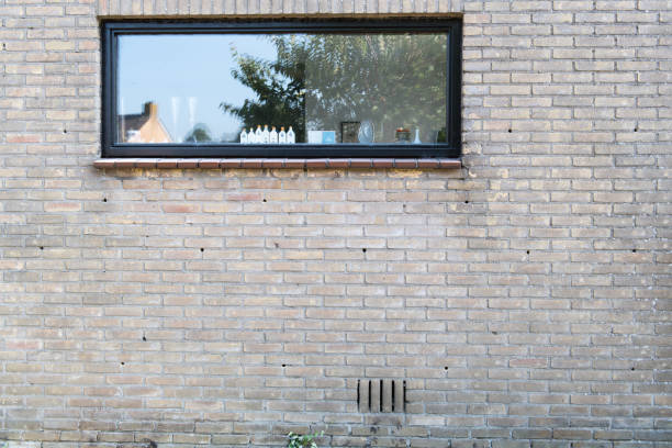 Drilling holes in a pattern in the joints between the bricks of the outer wall. After drilling these holes a technician will spray a mixture of various chemicals into those holes. The mixture will fill the hollow between the inner and outer wall and become an insulating foam.