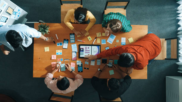 istock Top view of developer team working together to stick idea on board. Convocation. 2155021560