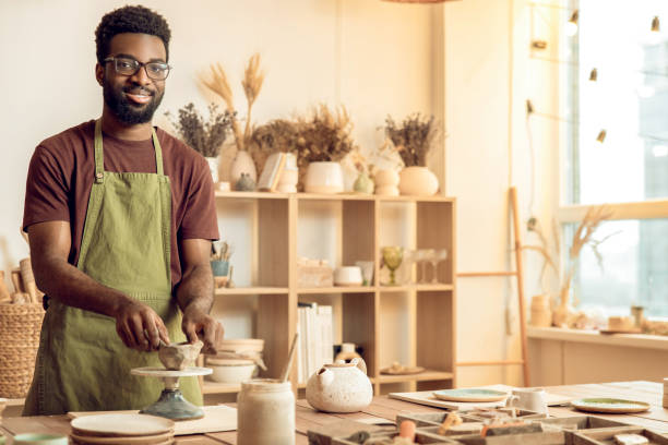 istock African american young man working with clay in pottery studio 2155026084