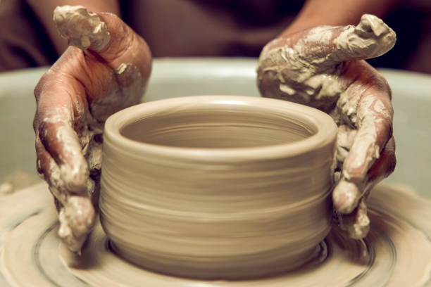 istock Sculptor working with a new product on a pottery wheel 2155026489