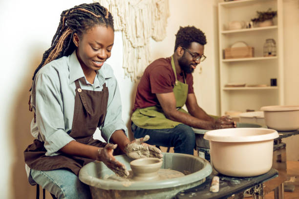 istock Two african american sculptors working on a pottery wheel 2155026493