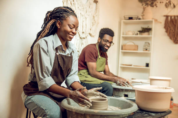 istock Two african american sculptors working on a pottery wheel 2155026501