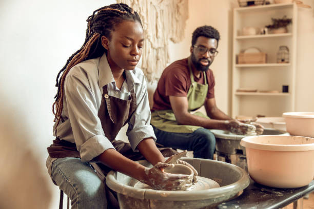 istock Man and woman having a pottery workshop and looking involved 2155026517