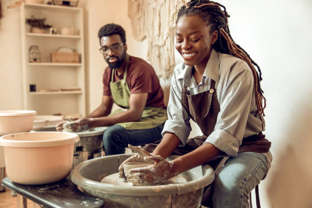 istock Man and woman having a pottery workshop and looking involved 2155026520