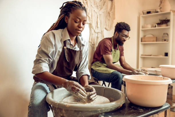 istock Man and woman having a pottery workshop and looking involved 2155026538