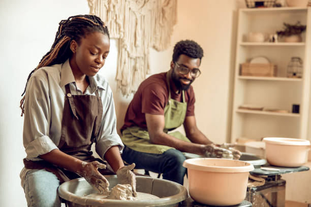 istock Man and woman having a pottery workshop and looking involved 2155026545