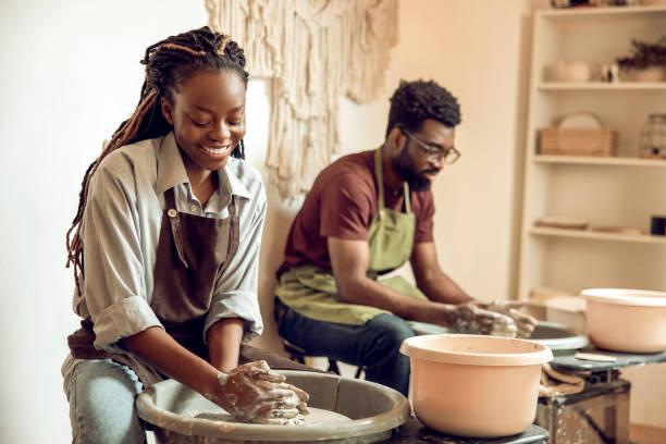 istock Man and woman having a pottery workshop and looking involved 2155026555