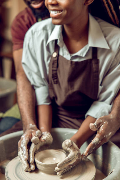 istock A happy couple working together on a pottery wheel and looking enjoyed 2155026558