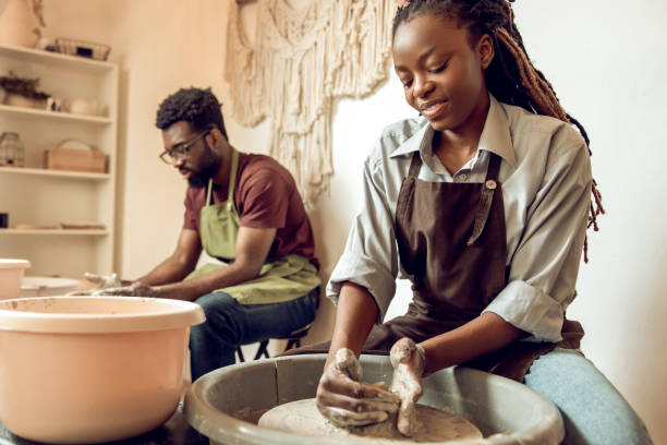 istock Man and woman having a pottery workshop and looking involved 2155026563