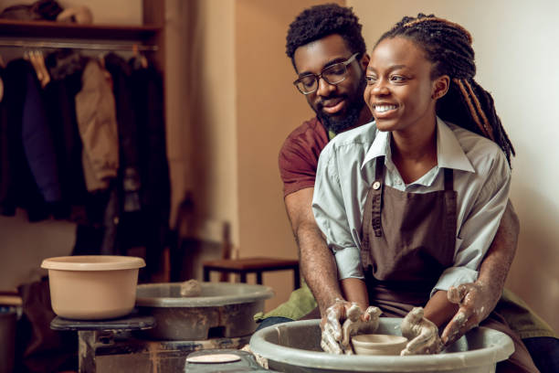 istock A happy couple working together on a pottery wheel and looking enjoyed 2155026582