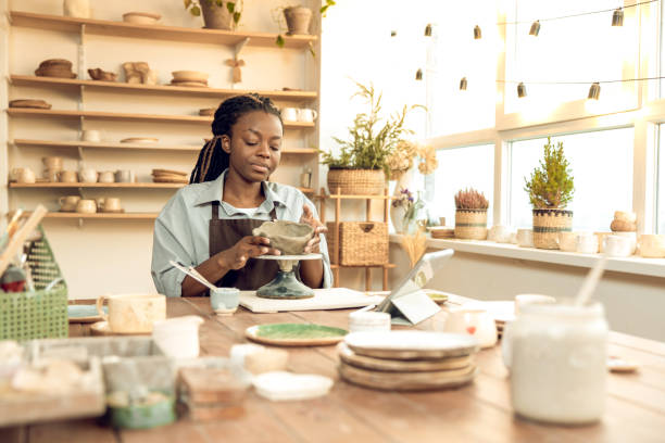 istock Dark-skinned beautiful sculptor conducting online class on ceramics 2155026618