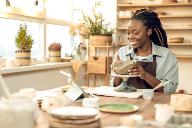 istock Dark-skinned beautiful sculptor conducting online class on ceramics 2155026619