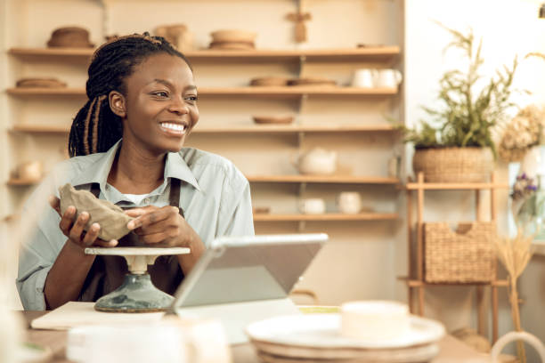istock Dark-skinned beautiful sculptor conducting online class on ceramics 2155026625