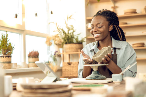 istock Dark-skinned beautiful sculptor conducting online class on ceramics 2155026626