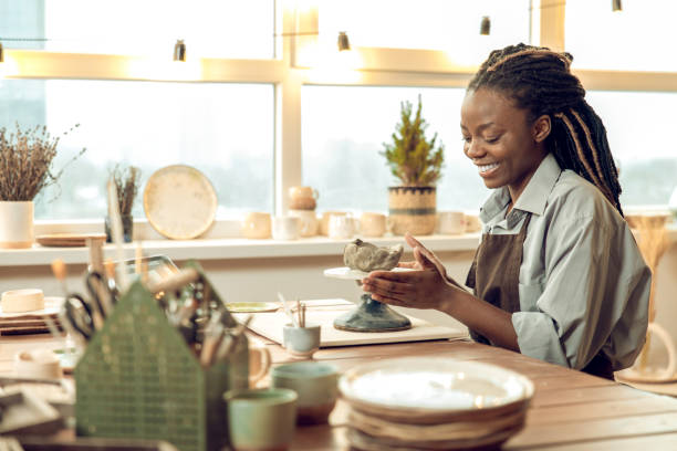 istock Young female sculptor working on new ceramic products 2155026655
