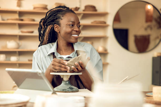 istock Dark-skinned beautiful sculptor conducting online class on ceramics 2155026658