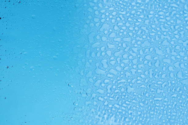 Blue glass with water drops. Wet glass.  Copy space.