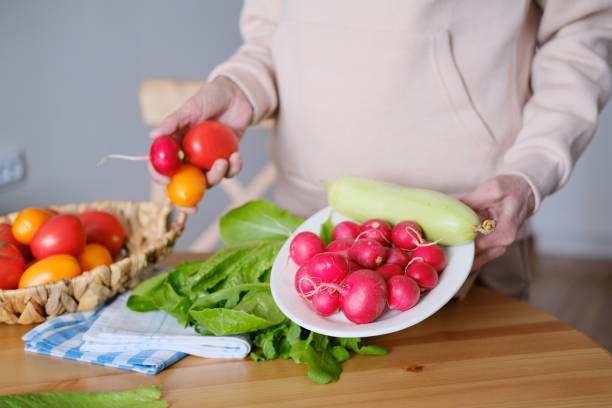 istock Plate with fresh vegetables in woman's hands 2155031099