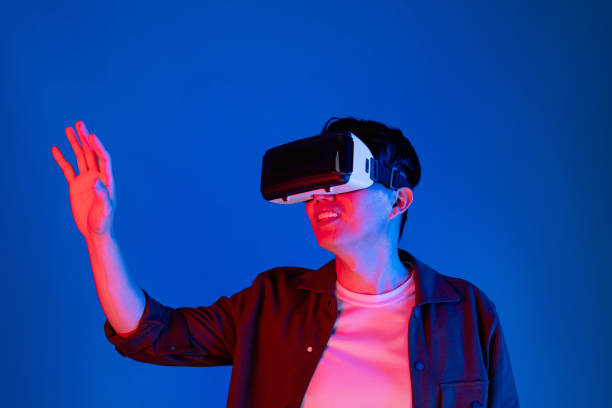 istock Asian man looking VR turn to metaverse pointing slide research. Contrivance. 2155031837