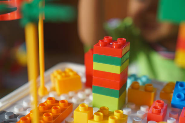 Children's hands assembling blocks to build a toy. In the development of small hand muscles. Select Focus.