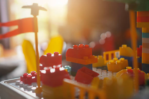 Children's hands assembling blocks to build a toy. In the development of small hand muscles. Select Focus.