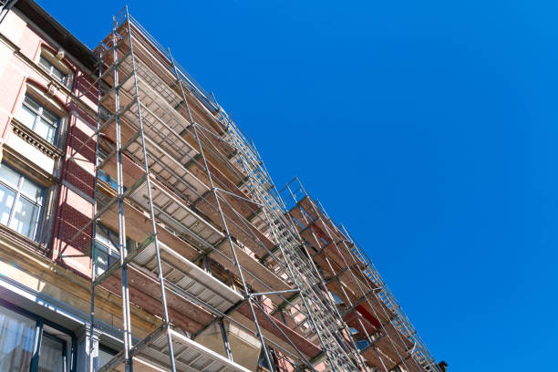 istock Scaffolding surrounding a house during facade renovation. 2155034472
