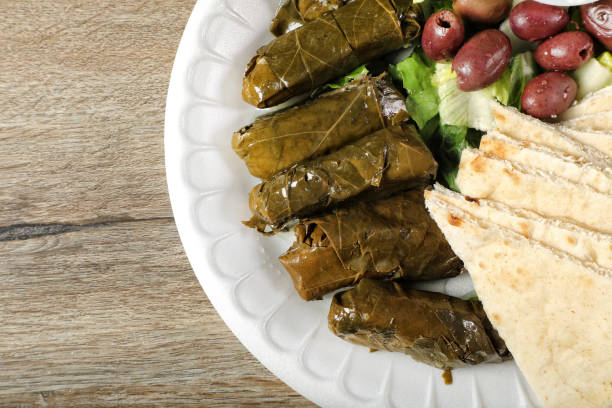 Stuffed grape leavesın plate on wooden table