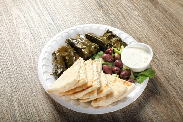 Stuffed grape leavesın plate on wooden table