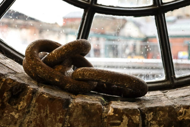 Rusty chains in a window of the dockyard in Bristol city, England