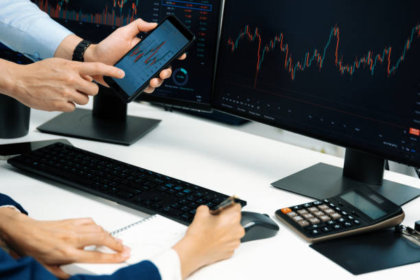 istock Cropped businessman checking smartphone with woman taking note . Infobahn. 2155039842