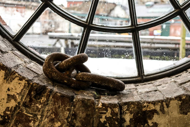 Rusty chains in a window of the dockyard in Bristol city, England