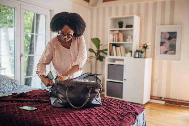 istock Person preparing to pack money in a bag 2155042521