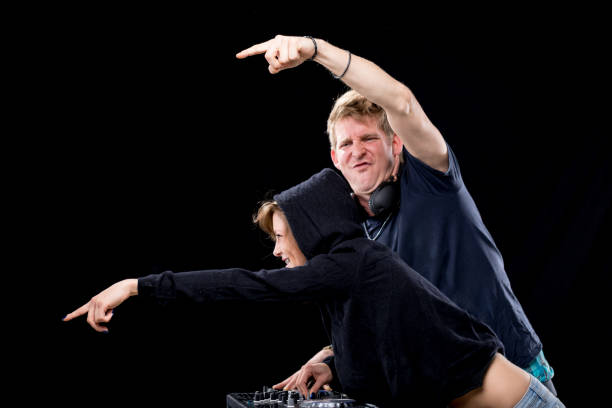 The vocalist records a song in a high-quality studio, using headphones and hand movements.