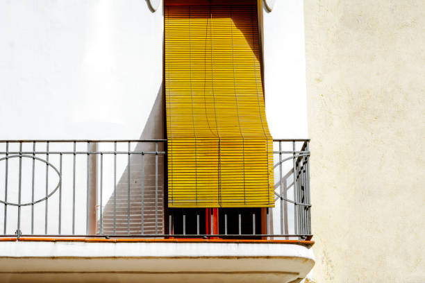 Urban Balcony with Yellow Blind on a Sunny Day
