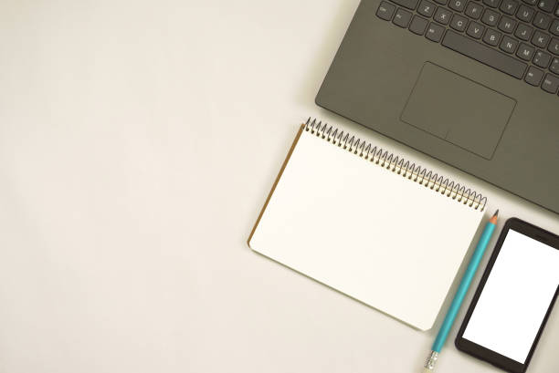 istock mobile phone with notebook and laptop on white background. 2155047728