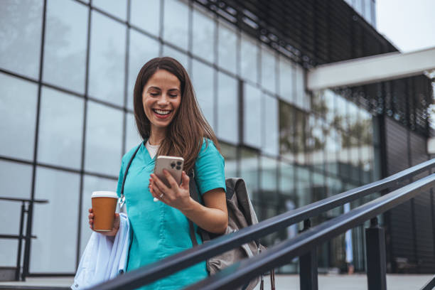 istock Smiling Caucasian Nurse Engages with Smartphone During Break 2155050613