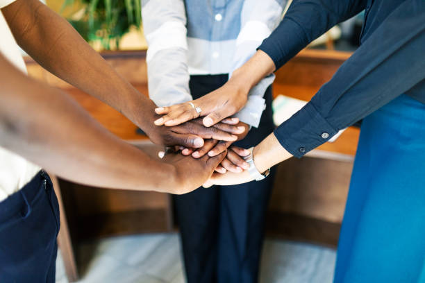 istock Business team putting hands together at the office 2155053769